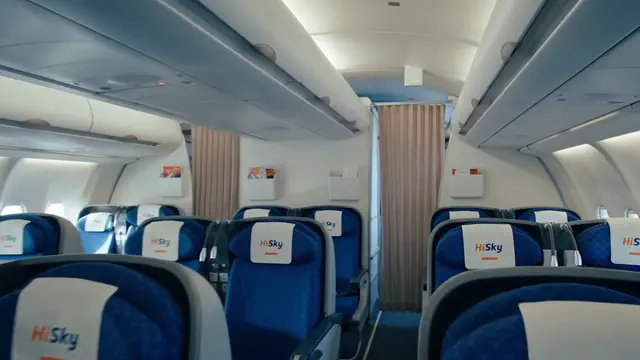 The business class cabin, looking down the seat rows.